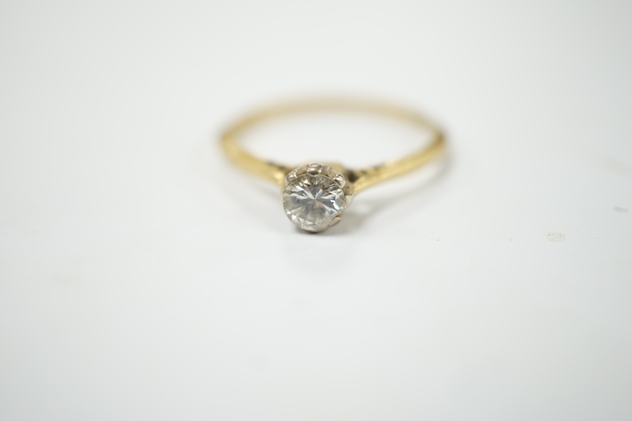 A modern 18tc gold and solitaire diamond set ring, size K, gross weight 1.4 grams. Condition -fair